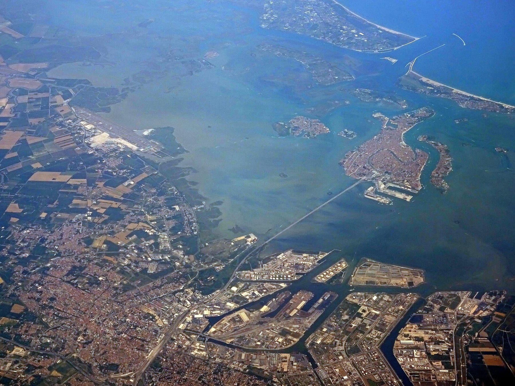 Aerial view of the Mestre mainland and the port of Marghera, with the Ponte della Libertà crossing the lagoon to the historic centre of Venice